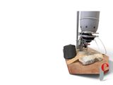 an image of a machine that has a piece of meat on it