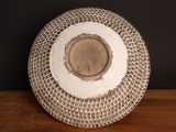 a white plate with a coin on it on a table