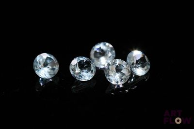 a close up of a group of diamonds sitting on top of a black surface