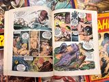 a book open on a table with comics on it