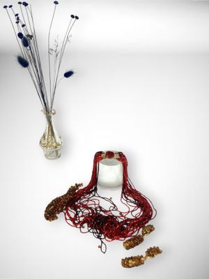 a vase with a bunch of dried flowers next to it