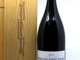 a bottle of wine sitting next to a wooden box