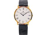 a gold and black watch with roman numerals on the face
