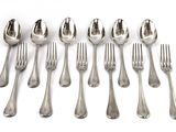six spoons and six forks are lined up on a white surface