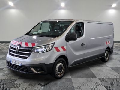 the silver van is parked on a checkered floor in a garage