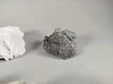 two pieces of white paper and a rock on a table
