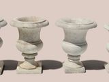 three white vases sitting next to each other on a table