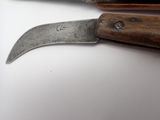 a knife that is laying on a table next to a knife