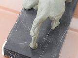 a statue of a dog that is on top of a table