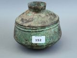 un petit pot vert muni d'une étiquette