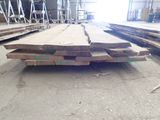 several pieces of wood are stacked on top of each other in a warehouse