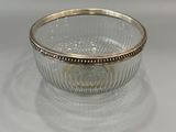 an image of a glass bowl with a gold rim on a white surface