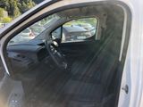 a white van with the door open and the driver ' s seat down