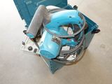 a blue machine that is sitting on the floor