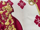 a close up of a red and gold tie with a gold design