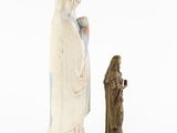 a statue of a woman and a man standing next to each other