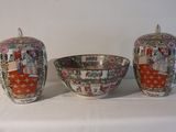 three vases and a bowl sitting on a table