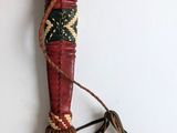 a wooden stick with a long handle on a white wall