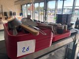 a red basket filled with kitchen utensils on a table