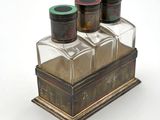 three salt and pepper shakers sitting on top of a wooden box