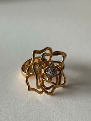 a close up of a gold ring on a white surface