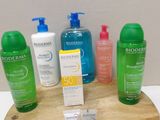 many different types of skin care products displayed on a wooden stand