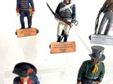 several figurines of soldiers are displayed on display in a glass case