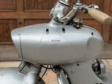 a close up of a motorcycle with a wooden handlebar