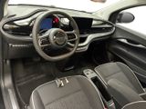 the interior of a small car with a steering wheel and dashboard