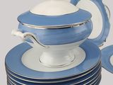 a blue and white dinner set with plates and a serving tray