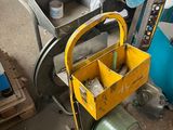 a yellow tool box sitting on top of a cart