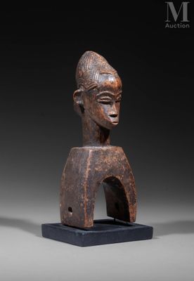 a wooden statue of a man with a hat on his head