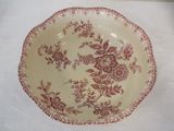 a brown and white plate with red flowers on it