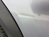 a close up of a car ' s door handle with a cat on it