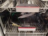 a dishwasher with a lot of dishes inside of it
