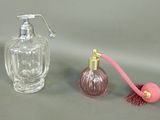 a bottle of perfume next to a bottle of perfume on a table