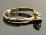 an image of a diamond ring on a reflective surface