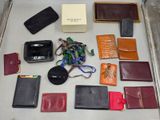 many different types of purses and wallets laid out on a table