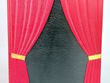 a picture of a red and black book with a red curtain