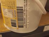 a bucket of food on a shelf in a store