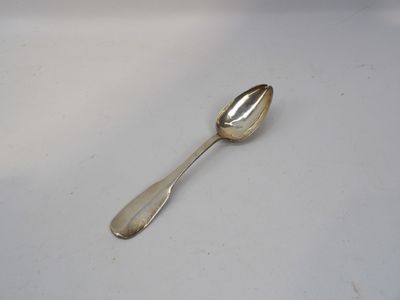 silver spoon on a white surface with a small spoon sticking out of it