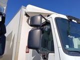 a white truck parked next to another truck in a parking lot