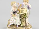a figurine of two children sitting on a tree stump