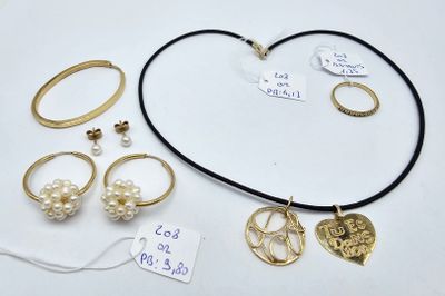 a lot of jewelry on a table with a price tag