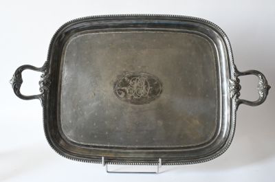 an antique silver plate with handles and handles on a stand