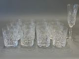 six glasses and a wine glass sitting on a table