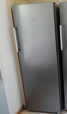 two stainless steel refrigerators side by side in a kitchen