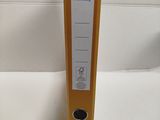 a yellow binder sitting on top of a white table