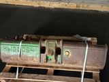 a wooden pallet with a metal object on top of it