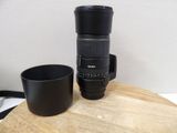 a camera lens and a cup on a wooden table